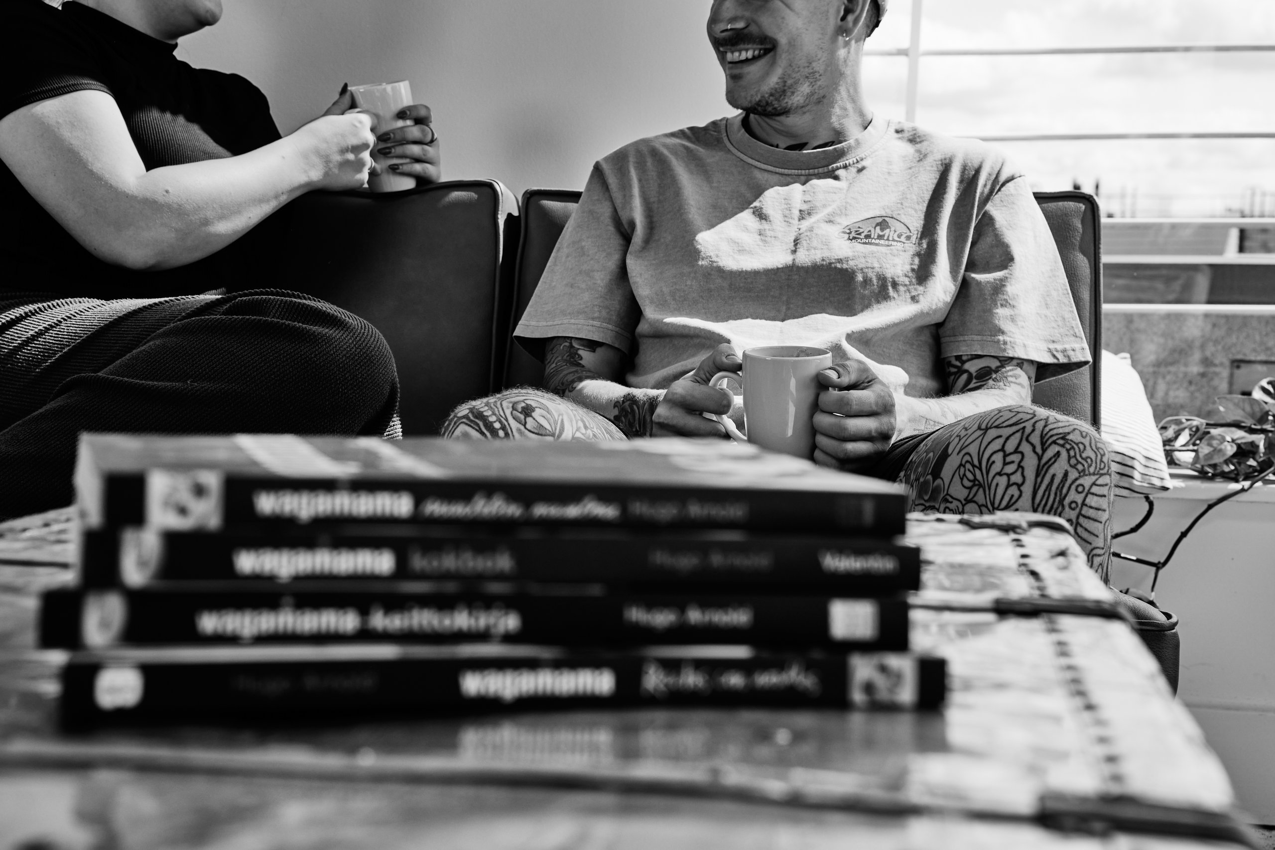 People sitting, tattoos, books.