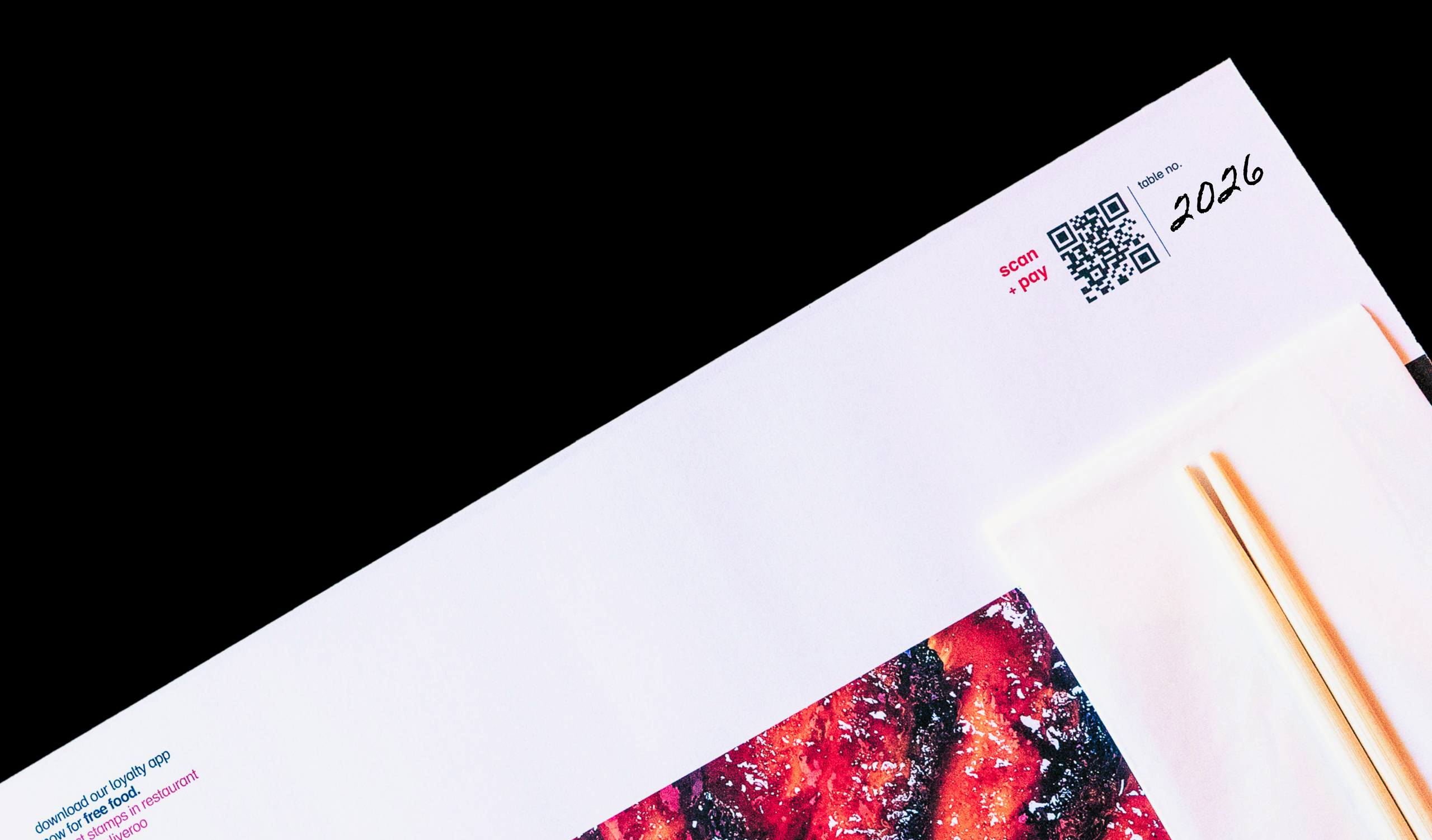 Top corner of a menu with a scan and pay QR code, table number 2026, and a pair of chopsticks.